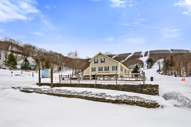 view of snow covered back of property