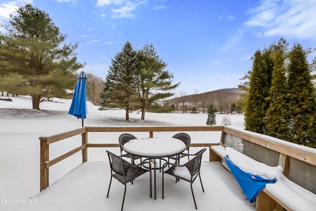 snow covered patio featuring a mountain view