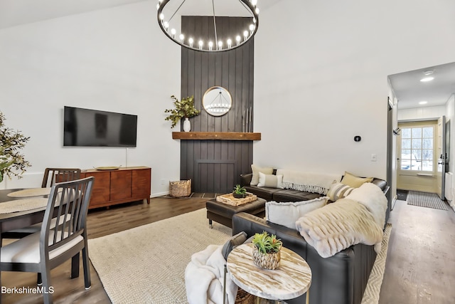 living room with hardwood / wood-style floors and a notable chandelier