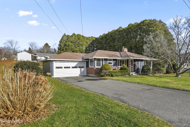 ranch-style home with a porch, a garage, and a front yard