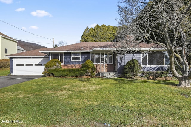 single story home featuring a front yard and a garage