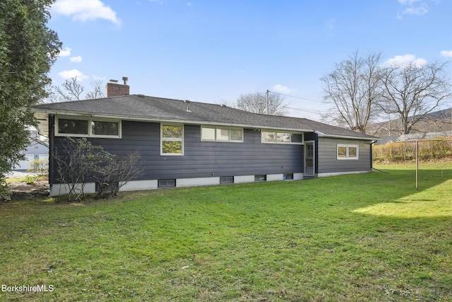 rear view of house featuring a yard