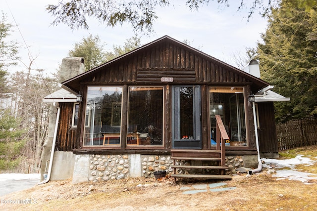 view of outdoor structure featuring a sunroom