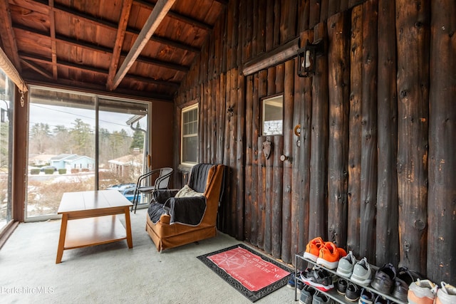 unfurnished sunroom featuring vaulted ceiling with beams and wooden ceiling