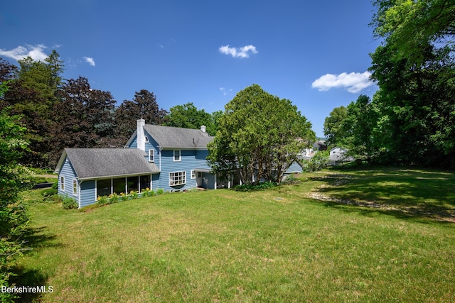 40 Crandall St, Adams, MA 01220 - rear view of property with a lawn, a chimney, a shingled roof, and a sunroom