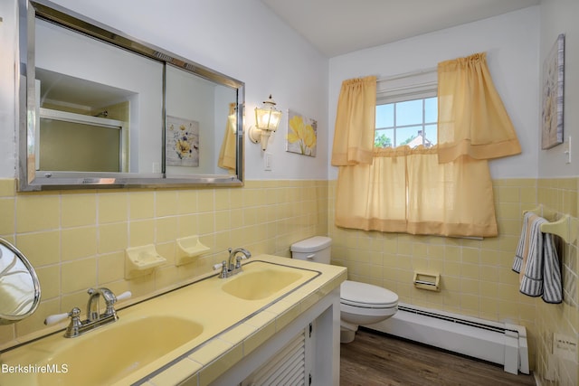 40 Crandall St, Adams, MA 01220 - bathroom featuring a baseboard heating unit, tile walls, an enclosed shower, wood finished floors, and double vanity
