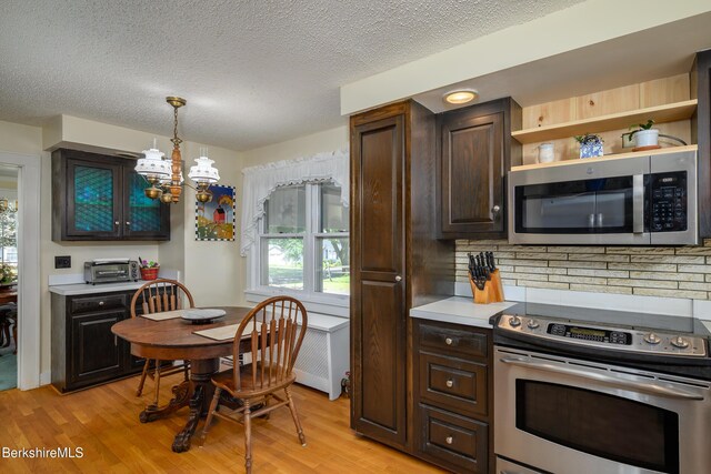 40 Crandall St, Adams, MA 01220 - kitchen with stainless steel appliances, light wood-style floors, a chandelier, dark brown cabinets, and a textured ceiling
