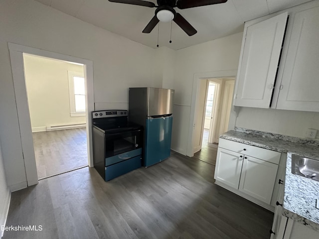 kitchen with dark hardwood / wood-style floors, white cabinetry, a baseboard radiator, light stone counters, and stainless steel appliances