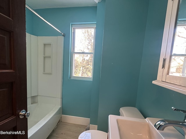 bathroom featuring shower / bath combination and toilet