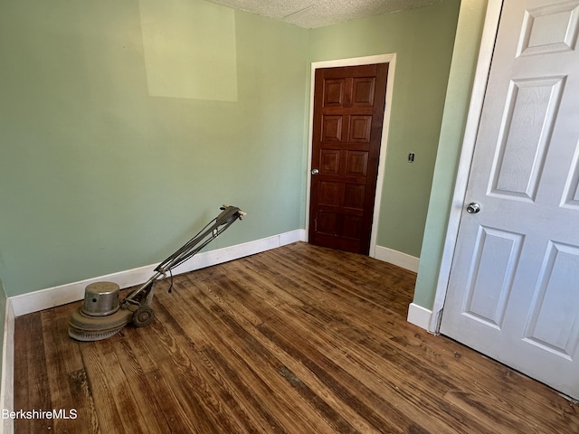 interior space with wood-type flooring and a textured ceiling