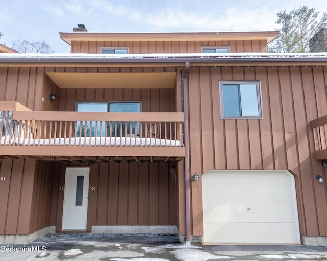 view of front of home with a balcony, a garage, and board and batten siding