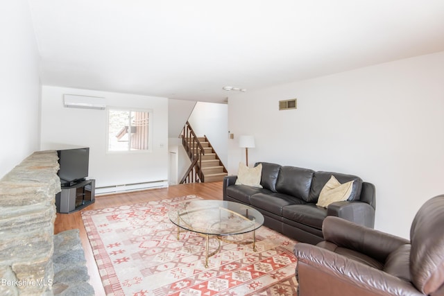 living room with wood finished floors, visible vents, stairs, an AC wall unit, and baseboard heating