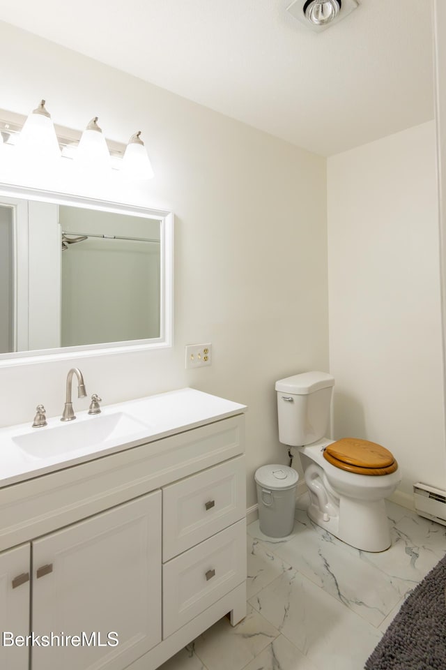 bathroom featuring toilet, a baseboard heating unit, vanity, baseboards, and marble finish floor