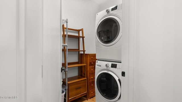 laundry area featuring stacked washer / drying machine