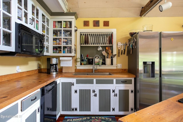 662 Foley Rd, Sheffield, MA 01257 - kitchen with butcher block countertops, black appliances, glass insert cabinets, and white cabinetry