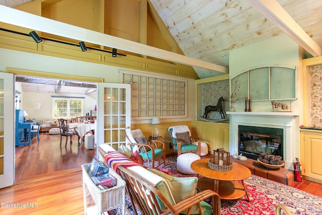 662 Foley Rd, Sheffield, MA 01257 - living area with wood finished floors, high vaulted ceiling, a glass covered fireplace, wooden ceiling, and french doors