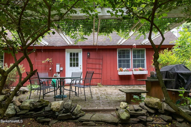 662 Foley Rd, Sheffield, MA 01257 - back of property featuring a patio, roof with shingles, and outdoor dining area