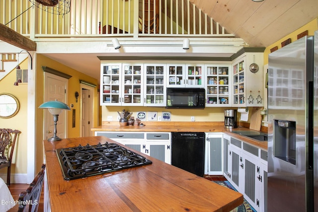 662 Foley Rd, Sheffield, MA 01257 - kitchen with wood counters, black appliances, high vaulted ceiling, wooden ceiling, and glass insert cabinets