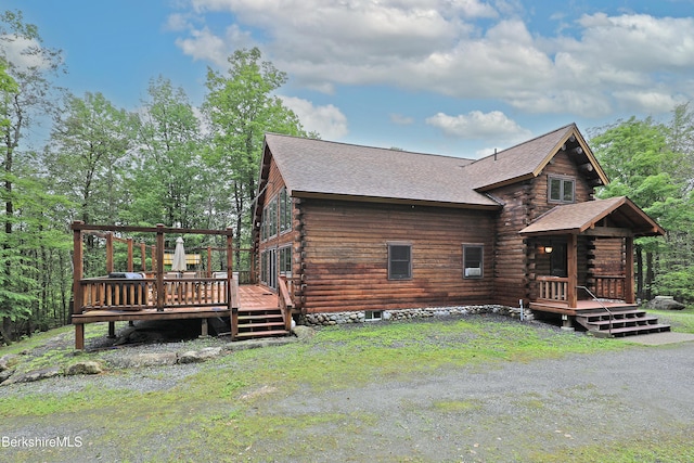 233 Algerie Rd, Becket, MA 01223 - view of side of property featuring log siding, a deck, and roof with shingles