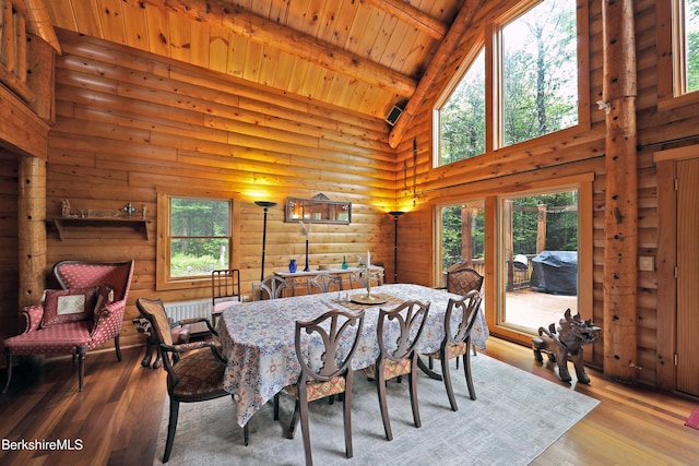 233 Algerie Rd, Becket, MA 01223 - dining space featuring high vaulted ceiling, plenty of natural light, a wooden ceiling with exposed beams, hardwood / wood-style floors, and log walls