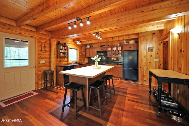 233 Algerie Rd, Becket, MA 01223 - kitchen with black appliances, dark wood-style floors, a breakfast bar, glass insert cabinets, and brown cabinetry