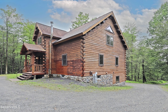 233 Algerie Rd, Becket, MA 01223 - view of side of property with log siding and roof with shingles
