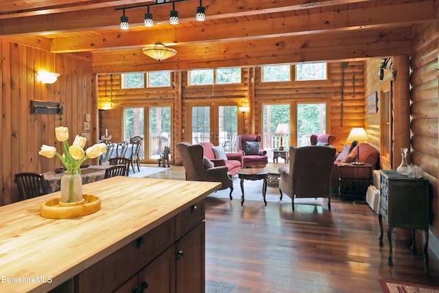 233 Algerie Rd, Becket, MA 01223 - living room featuring dark wood-type flooring, beamed ceiling, rustic walls, french doors, and wooden walls