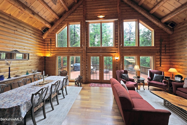 233 Algerie Rd, Becket, MA 01223 - living area featuring high vaulted ceiling, a wooden ceiling with exposed beams, rustic walls, hardwood / wood-style floors, and healthy amount of natural light
