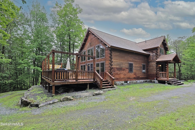 233 Algerie Rd, Becket, MA 01223 - back of house featuring log exterior, a wooden deck, and roof with shingles