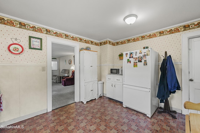 15 Summit Ave, Adams, MA 01220 - kitchen with freestanding refrigerator, wallpapered walls, brick patterned flooring, a wainscoted wall, and stainless steel microwave