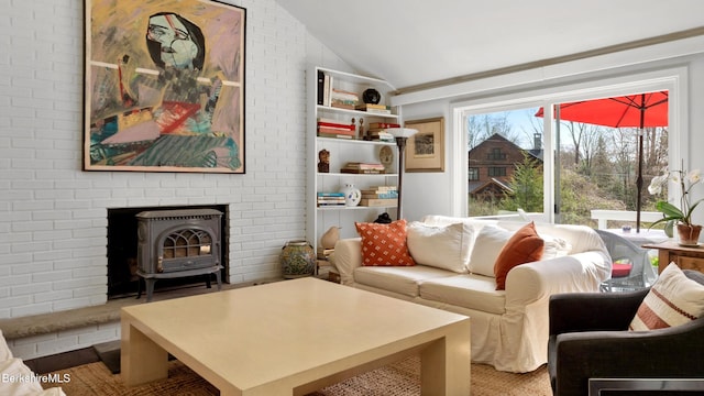 living room with a wood stove and vaulted ceiling