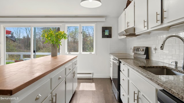 kitchen with decorative backsplash, a baseboard radiator, under cabinet range hood, a sink, and appliances with stainless steel finishes