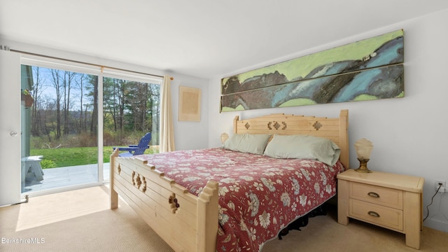 bedroom with light carpet and access to exterior