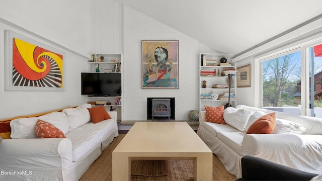 living area with a wood stove and lofted ceiling