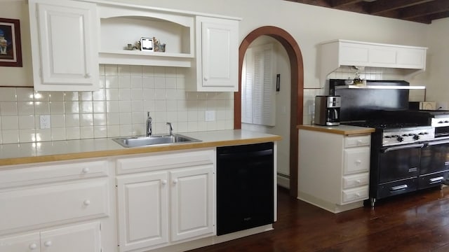 kitchen with white cabinets, beam ceiling, sink, and black appliances