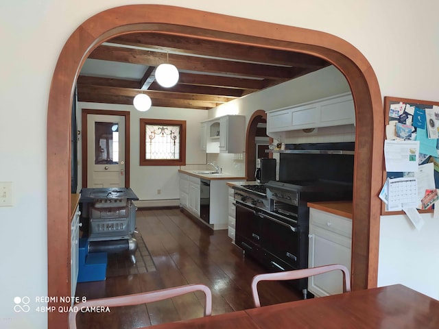 kitchen featuring dishwasher, dark wood-type flooring, white cabinets, sink, and beamed ceiling