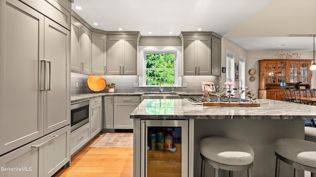 13 Taconic Ave, Lenox, MA 01240 - kitchen with wine cooler, built in appliances, gray cabinets, a breakfast bar, and recessed lighting