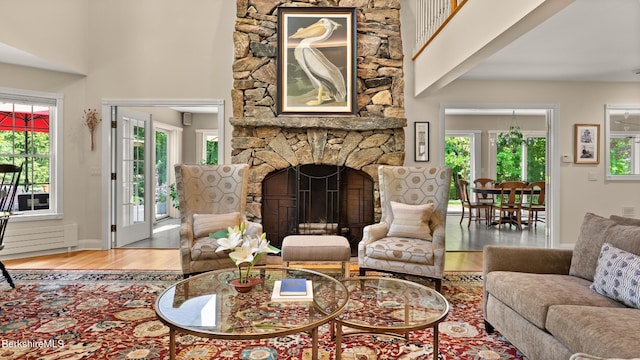 13 Taconic Ave, Lenox, MA 01240 - living area featuring wood finished floors, a high ceiling, and a stone fireplace