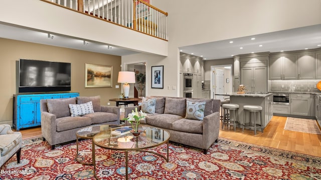 13 Taconic Ave, Lenox, MA 01240 - living room featuring light wood finished floors, a towering ceiling, and recessed lighting