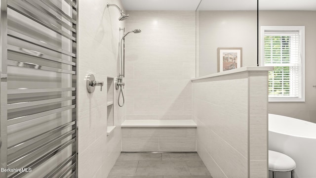 13 Taconic Ave, Lenox, MA 01240 - bathroom featuring radiator heating unit, healthy amount of natural light, tiled shower, and a towel warmer