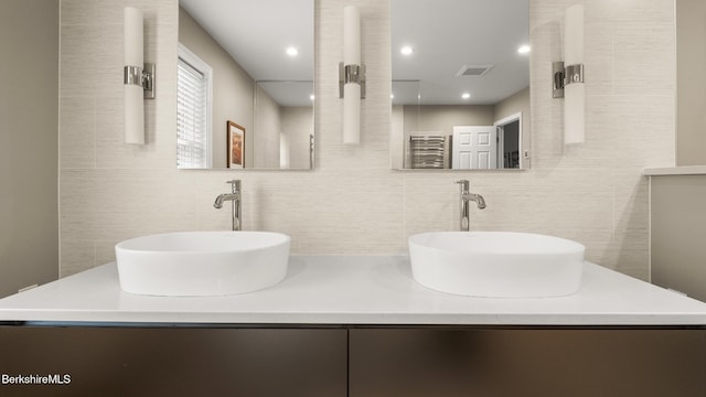 13 Taconic Ave, Lenox, MA 01240 - full bath featuring decorative backsplash, tile walls, double vanity, and recessed lighting