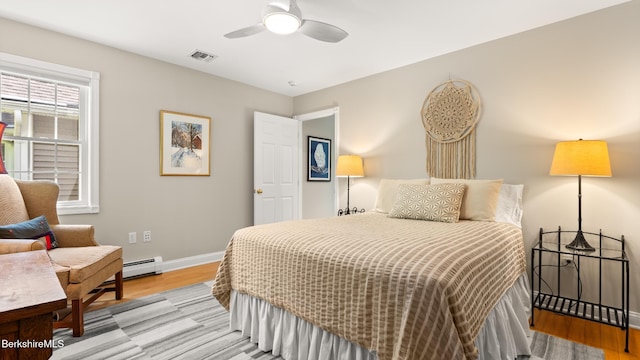 13 Taconic Ave, Lenox, MA 01240 - bedroom featuring a baseboard heating unit, wood finished floors, and a ceiling fan