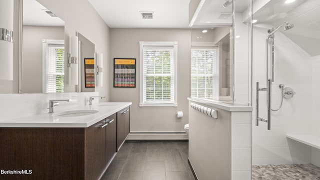 13 Taconic Ave, Lenox, MA 01240 - full bathroom with a baseboard heating unit, double vanity, tiled shower, and plenty of natural light