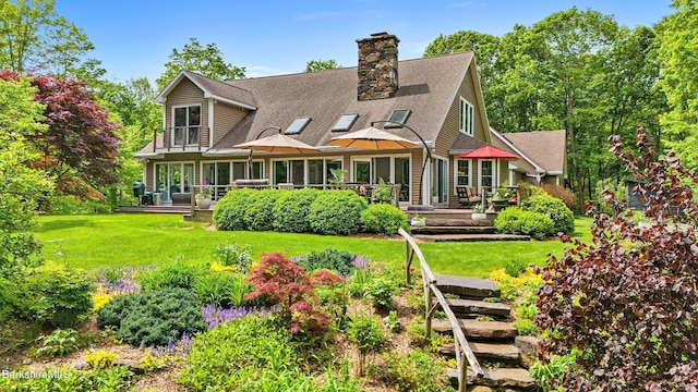 13 Taconic Ave, Lenox, MA 01240 - rear view of property featuring a yard, a wooden deck, a chimney, and a shingled roof