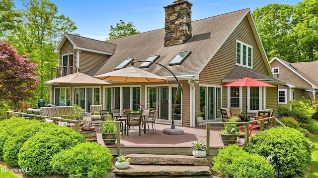 13 Taconic Ave, Lenox, MA 01240 - rear view of property featuring a shingled roof, outdoor dining space, a wooden deck, and a chimney