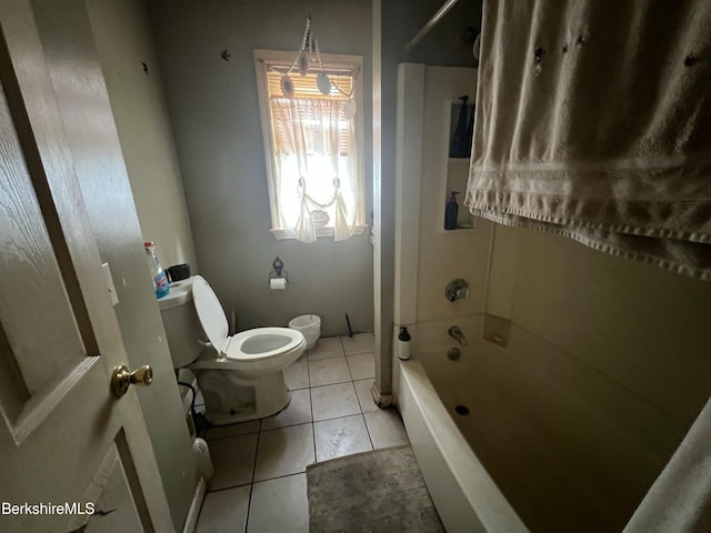 bathroom with bathtub / shower combination, tile patterned floors, and toilet