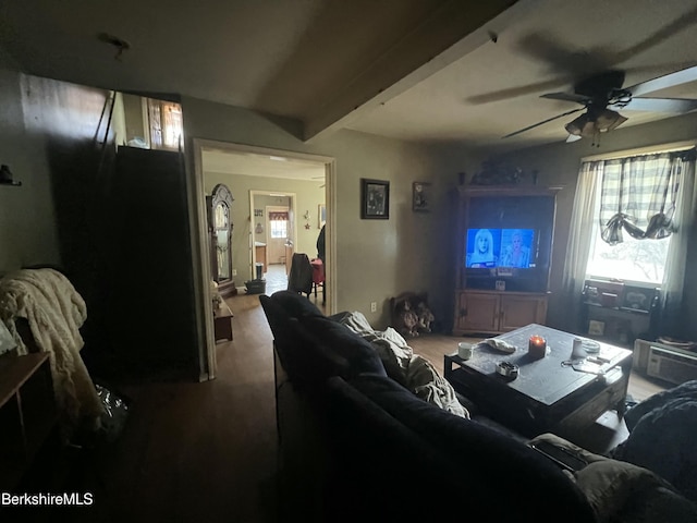 living room featuring ceiling fan and beam ceiling