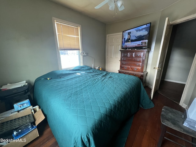 bedroom featuring ceiling fan and dark wood-type flooring