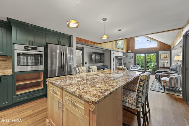 171 Lake Shore Dr, Otis, MA 01253 - kitchen featuring green cabinetry, appliances with stainless steel finishes, light stone counters, light wood-style floors, and vaulted ceiling