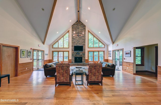 171 Lake Shore Dr, Otis, MA 01253 - living area featuring french doors, light wood-style flooring, high vaulted ceiling, beam ceiling, and a fireplace